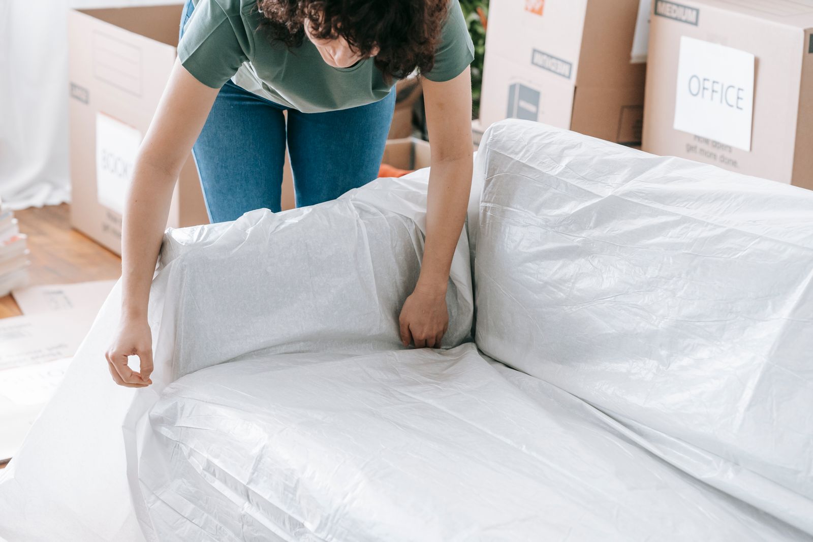 BlueLine movers wrapping furniture in moving blankets